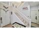 Bright foyer showcasing a staircase with white railings and tiled flooring at 9412 Jewel Lake Ave, Las Vegas, NV 89166