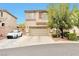 Two-story home with neutral toned exterior, driveway, two car garage, and mature landscaping at 9412 Jewel Lake Ave, Las Vegas, NV 89166
