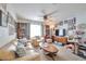Comfortable living room featuring a leather sofa and plenty of natural light at 9412 Jewel Lake Ave, Las Vegas, NV 89166