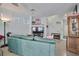 Bright living room with a comfortable green sofa and open staircase, creating a welcoming space at 9412 Jewel Lake Ave, Las Vegas, NV 89166
