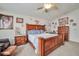 Bright main bedroom with a wooden bed frame, carpet flooring, and neutral walls at 9412 Jewel Lake Ave, Las Vegas, NV 89166