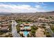 Wide aerial view of a planned community featuring a pool and vast views of the city and mountains at 9465 Perennial View Ave, Las Vegas, NV 89148