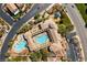 Stunning aerial view of the community pools, play area, and manicured landscaping offering residents a resort-style living experience at 9465 Perennial View Ave, Las Vegas, NV 89148
