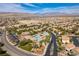 Breathtaking aerial view of community with pools, mountains, and lush landscaping, enhancing its appeal at 9465 Perennial View Ave, Las Vegas, NV 89148