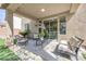 Outdoor patio with cushioned seating and view of sliding doors at 9465 Perennial View Ave, Las Vegas, NV 89148