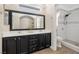 Bright bathroom with double vanity, walk-in shower, and framed mirror at 9465 Perennial View Ave, Las Vegas, NV 89148