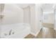Bright bathroom showcases a large bathtub with tile surround and wood-look flooring at 9465 Perennial View Ave, Las Vegas, NV 89148