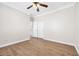 Bright bedroom with hardwood floors, ceiling fan, closet, and fresh paint, offering a clean and comfortable living space at 9465 Perennial View Ave, Las Vegas, NV 89148
