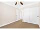 Carpeted bedroom featuring a ceiling fan, natural light, and a walk-in closet at 9465 Perennial View Ave, Las Vegas, NV 89148