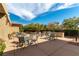 A community space with tables and chairs, a built-in grill, and landscaped surroundings at 9465 Perennial View Ave, Las Vegas, NV 89148