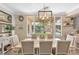 Elegant dining room with a large window, backyard view, and contemporary chandelier at 9465 Perennial View Ave, Las Vegas, NV 89148