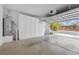 Spacious two car garage provides ample storage space with custom cabinets and open door at 9465 Perennial View Ave, Las Vegas, NV 89148