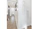 Hallway has neutral colors, tile flooring, and is decorated with modern wall art at 9465 Perennial View Ave, Las Vegas, NV 89148