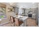 Modern kitchen with gray cabinets, quartz countertops, stainless steel appliances, and a breakfast bar at 9465 Perennial View Ave, Las Vegas, NV 89148