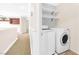 Convenient laundry room features a modern washer and dryer set with added shelving for storage at 9465 Perennial View Ave, Las Vegas, NV 89148
