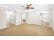 Spacious living room featuring a ceiling fan and archway leading to a built-in office space at 9465 Perennial View Ave, Las Vegas, NV 89148