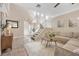 Bright and open living area features a staircase, tile floors, and a comfortable sectional sofa at 9465 Perennial View Ave, Las Vegas, NV 89148