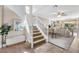 Spacious living room and staircase offers a view to the dining area with comfortable seating and neutral décor at 9465 Perennial View Ave, Las Vegas, NV 89148