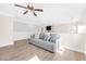 Open-concept living room featuring wood floors, a ceiling fan, and natural light at 9465 Perennial View Ave, Las Vegas, NV 89148