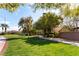 A well-manicured neighborhood park with mature trees, walking path, and green spaces at 9465 Perennial View Ave, Las Vegas, NV 89148