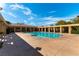 Beautiful community pool area with covered seating and clear blue water on a sunny day at 9465 Perennial View Ave, Las Vegas, NV 89148