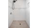 Modern shower featuring white tile, black shower head, and an accent stripe, creating a clean and spa-like atmosphere at 9465 Perennial View Ave, Las Vegas, NV 89148