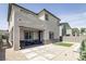 This backyard has a covered patio, a seating area, an artificial turf lawn, and a modern water feature at 9732 Abel Cliff St, Las Vegas, NV 89143