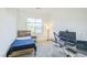 Bright bedroom with a minimalist bed, desk, and large window, creating a modern space at 9732 Abel Cliff St, Las Vegas, NV 89143