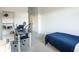 Bright bedroom with a minimalist bed, desk, and large window, creating a modern space at 9732 Abel Cliff St, Las Vegas, NV 89143