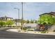 A neighborhood entrance with a sign, landscaping, and new construction homes at 9732 Abel Cliff St, Las Vegas, NV 89143