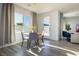 Bright dining area features a wood table, seating for four, and a view of the backyard at 9732 Abel Cliff St, Las Vegas, NV 89143