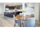Cozy dining area with wood table, seating for four, and adjacent kitchen with island at 9732 Abel Cliff St, Las Vegas, NV 89143