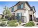 Modern two story home with a neutral exterior, stone accents, desert landscaping and covered entry at 9732 Abel Cliff St, Las Vegas, NV 89143