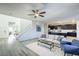 Open floor plan featuring a living area, staircase, and kitchen with island at 9732 Abel Cliff St, Las Vegas, NV 89143