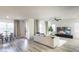 Bright living area with modern decor, hardwood floors, and a dining space at 9732 Abel Cliff St, Las Vegas, NV 89143