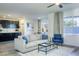 Open-concept living space featuring a modern kitchen, comfortable seating, and a bright interior at 9732 Abel Cliff St, Las Vegas, NV 89143