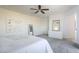 Large main bedroom with light walls, plush carpet, ceiling fan, and en-suite bathroom at 9732 Abel Cliff St, Las Vegas, NV 89143