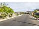 View of a quiet neighborhood street with sidewalks and landscaping at 9732 Abel Cliff St, Las Vegas, NV 89143