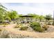 A neighborhood park area with a pergola, seating, and desert landscaping at 9732 Abel Cliff St, Las Vegas, NV 89143