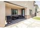 This covered patio has wicker furniture, a grill, access to the backyard and is ready for relaxing and entertaining at 9732 Abel Cliff St, Las Vegas, NV 89143