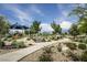 Community playground featuring modern equipment, lush landscaping, and walking path under a sunny sky at 9732 Abel Cliff St, Las Vegas, NV 89143