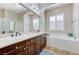 Bright bathroom boasts a double vanity, soaking tub, and a large mirror at , Las Vegas, NV 89149