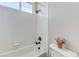 Bathroom showcases a white tiled tub/shower and white toilet with small flower accent at , Las Vegas, NV 89149
