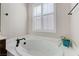 Bathroom featuring a soaking tub, a bright window, and neutral color scheme at , Las Vegas, NV 89149