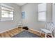 Small bedroom with hardwood flooring, neutral paint, and two windows for natural light at , Las Vegas, NV 89149