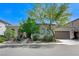 Charming single-story home with a well-manicured front yard and two-car garage under a brilliant, sunny sky at , Las Vegas, NV 89149