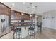 Gourmet kitchen features dark wood cabinets, stainless appliances, and granite countertops at , Las Vegas, NV 89149