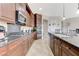 Kitchen showcasing dark wood cabinets, granite countertops, stainless appliances, and an island sink at , Las Vegas, NV 89149