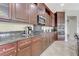 Gourmet kitchen features dark wood cabinets, stainless appliances, and granite countertops at , Las Vegas, NV 89149