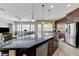 The kitchen island flows to the open-plan living spaces offering stainless appliances and dark wood at , Las Vegas, NV 89149